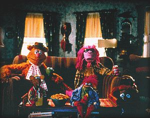 The Muppets watch tv in their boarding house